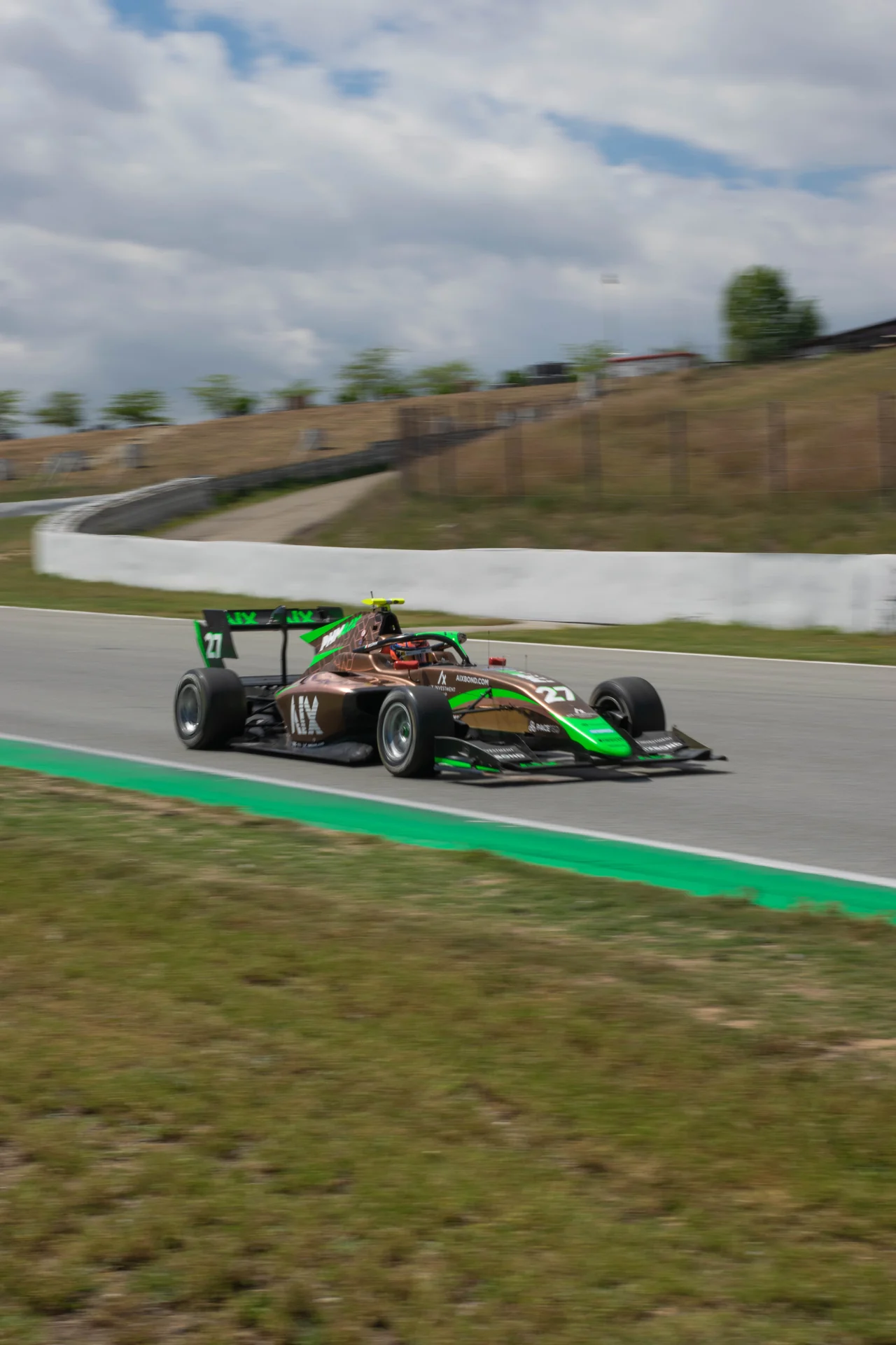 Green Formula racing car on circuit