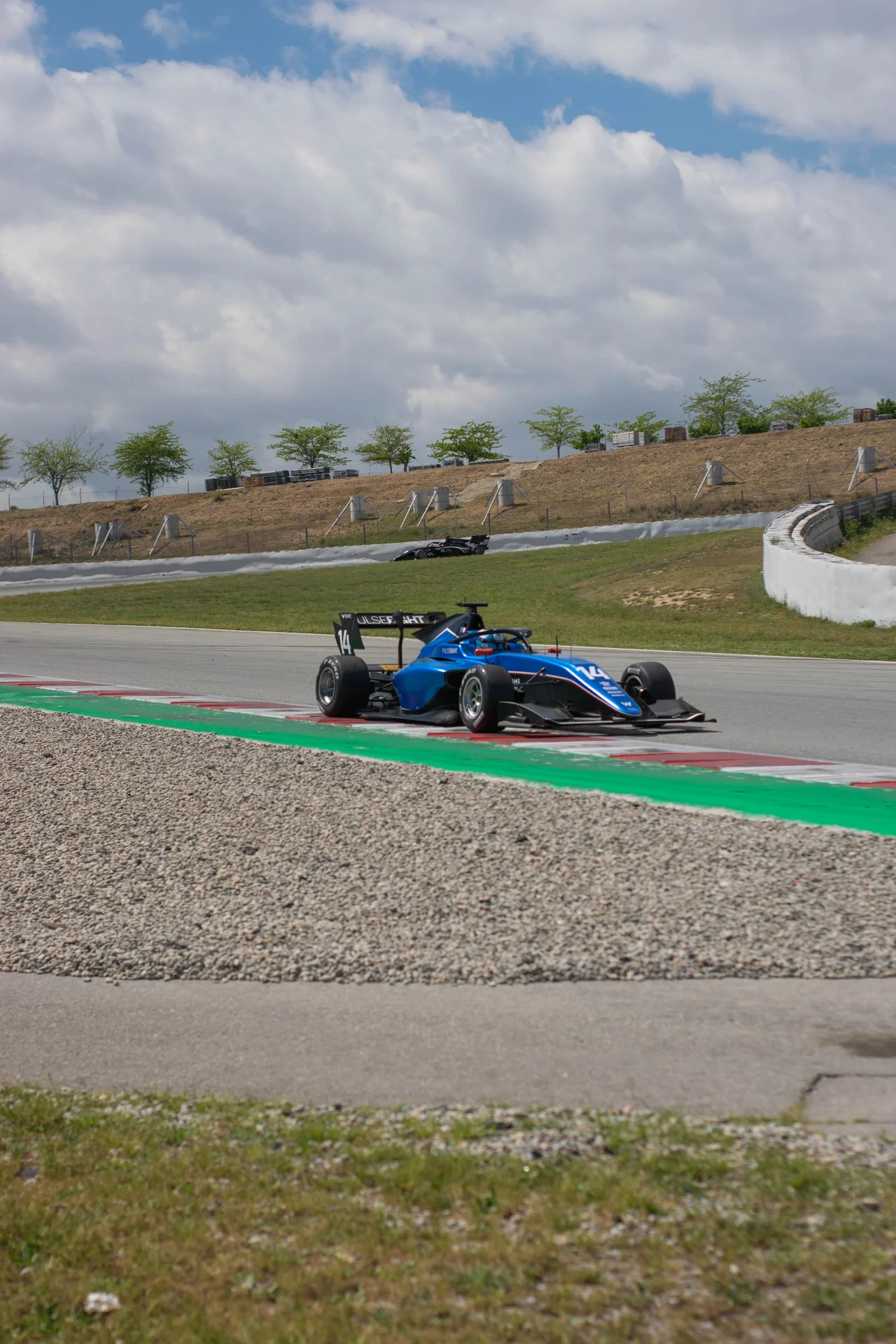 Blue Formula racing car captured in motion